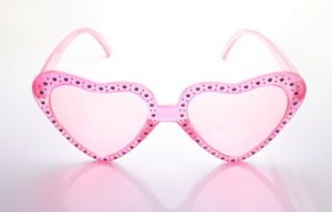 Pink heart shaped sunglasses on white background.